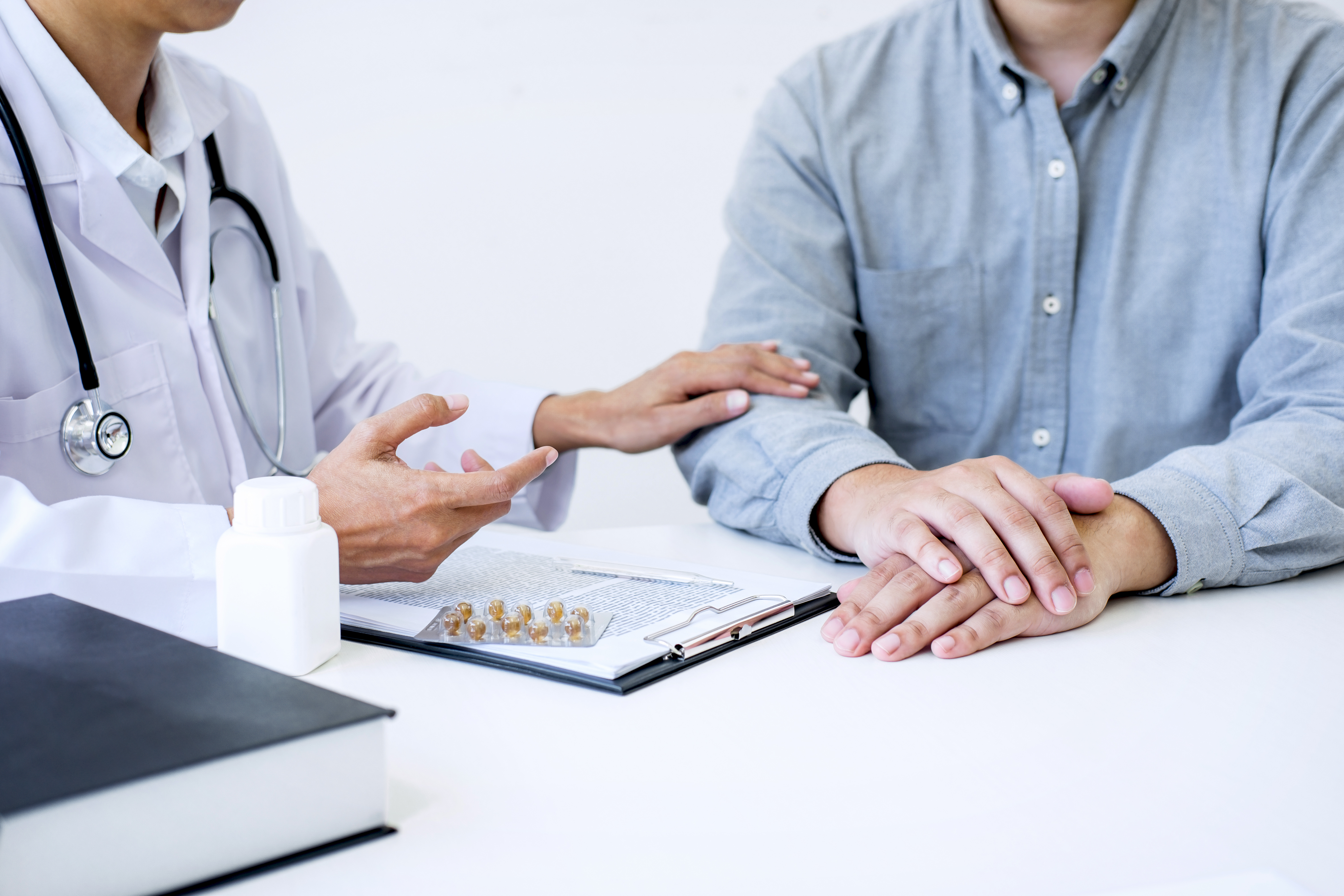 Patient in consultation with a doctor, looking for answers about persistent pain